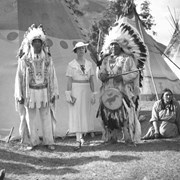 Cover image of John Chiniki, unknown woman, George McLean (Tatâga Mânî) (Walking Buffalo) (right), Flora (Crawler) McLean (far right)
